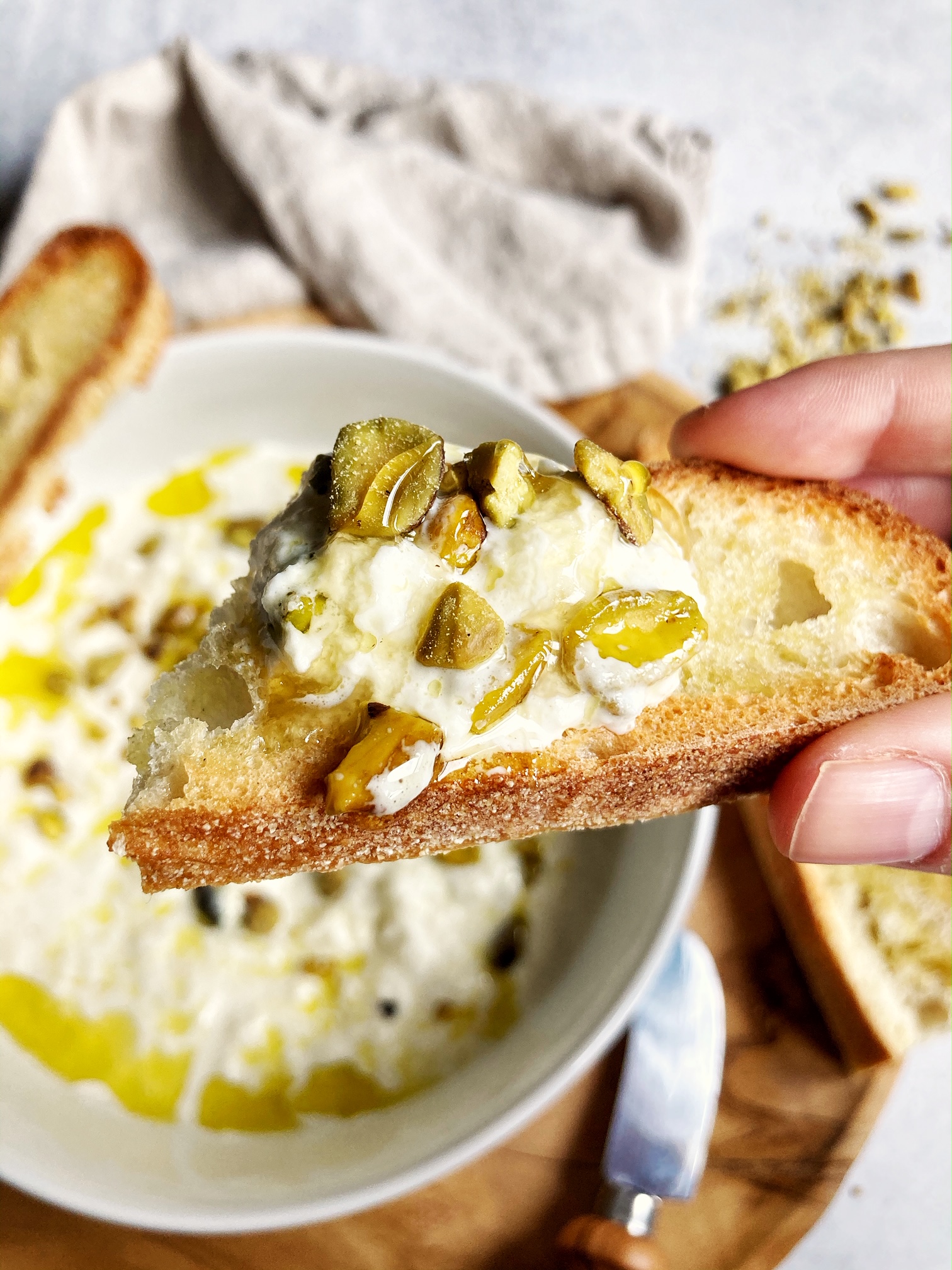 cheese dish with nuts, honey, and olive oil on crostini