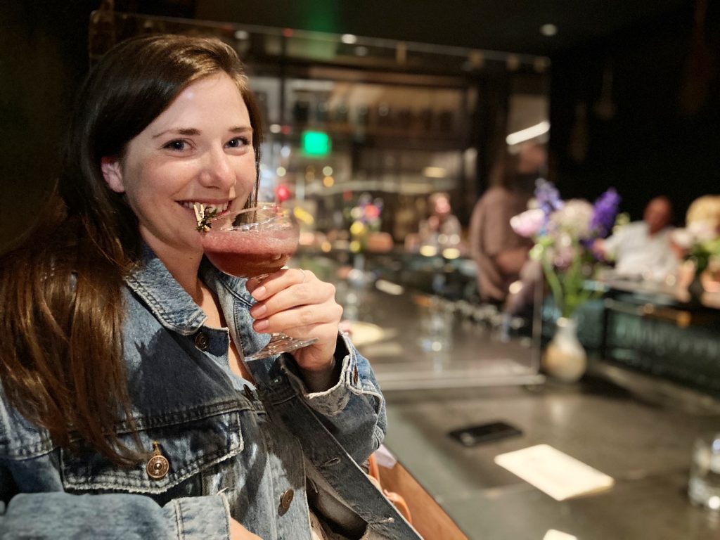 sydney isaacs drinking a cocktail at nonnesuch in oklahoma city, OK