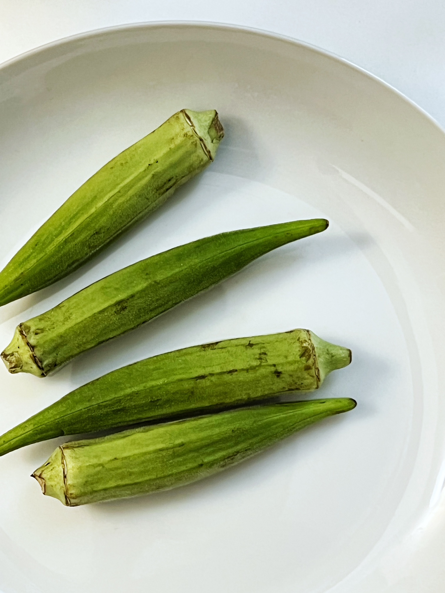 whole okra on a white dish