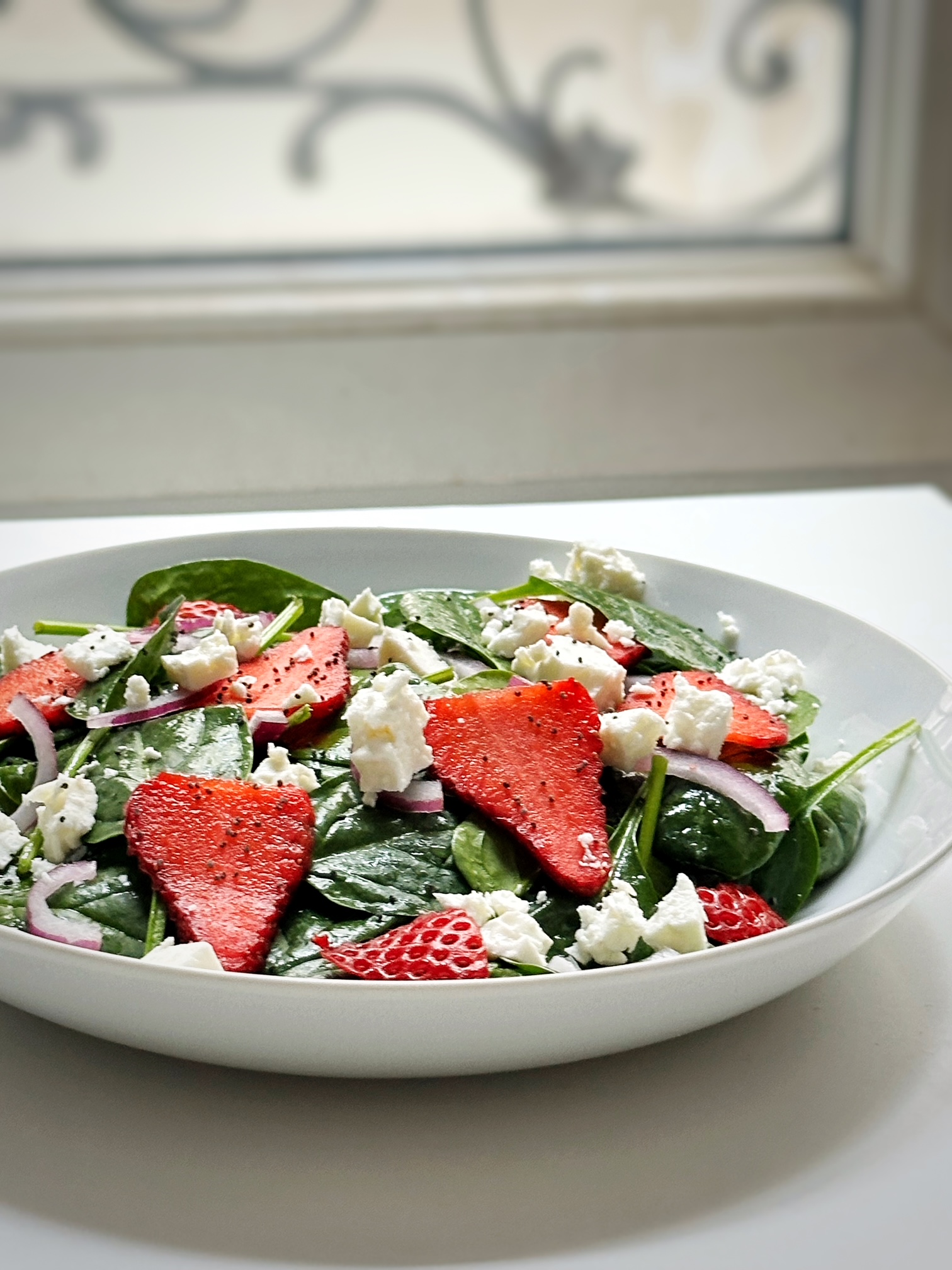 strawberry spinach salad on a table